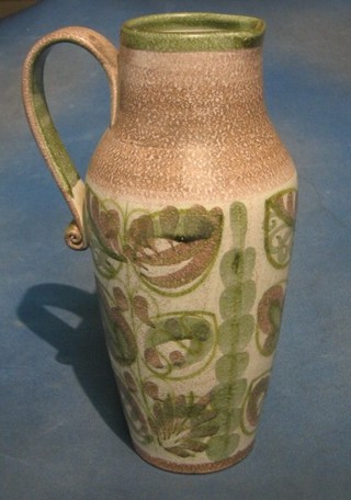 A large Denby Art Pottery green glazed jug with floral decoration, the base incised signature mark 14"