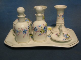 An Edwardian porcelain 7 piece dressing table set with lozenge shaped tray, 2 scent bottle, ring tree, pair of candlesticks, jar and cover (banding rubbed)