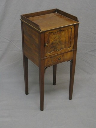 A 19th Century Georgian style mahogany pot cupboard, fitted a three-quarter gallery and cupboard enclosed by panelled doors, the base fitted a drawer and raised on square tapering supports 14" (crack to door of cupboard)