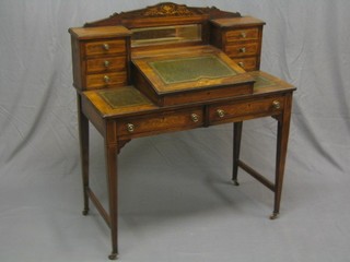 A Victorian inlaid rosewood writing table, the raised back fitted a rectangular mirror and with writing slope to the centre inset a tooled leather writing surface, flanked by 6 short drawers, the base fitted 2 long drawers, raised on square tapering supports ending in ceramic castors 36"