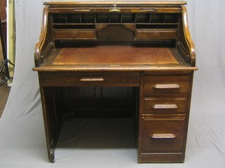 A 19th Century oak roll top pedestal desk with well fitted interior above 1 long and 3 short drawers 42"