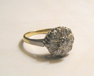 A lady's 18ct gold cluster dress ring with illusion set diamonds
