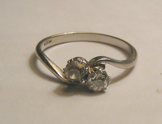 A lady's 18ct gold cross-over dress ring set 2 diamonds 