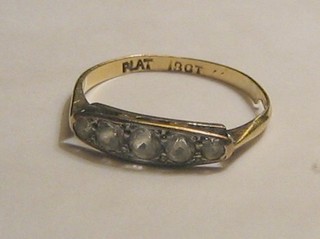 A lady's 18ct gold dress ring set 5 diamonds, supported by further diamonds
