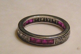 A lady's 18ct white gold or platinum eternity ring set rubies and diamonds
