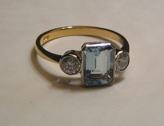 A lady's 18ct gold dress ring set a rectangular cut aquamarine and 2 diamonds