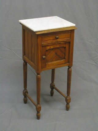 A 19th Century French pine pot cupboard with white veined marble top, fitted a drawer and cupboard enclosed by panelled door, raised on turned and block supports 15"