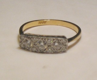 A lady's gold dress ring set 3 diamonds supported by numerous other diamonds (approx 0.45ct)