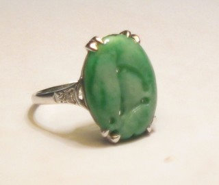 A lady's 18ct white gold or platinum dress ring set a pieced green hardstone