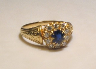A lady's attractive gold dress ring set a sapphire supported by numerous diamonds