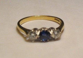 A lady's 18ct gold dress ring set sapphire and 2 diamonds