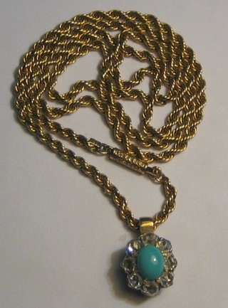 A lady's attractive gold pendant set a cabouchon cut turquoise surrounded by 8 diamonds, hung on a 15ct gold rope chain