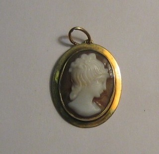 A shell carved cameo pendant contained in a gold mount