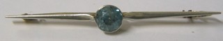 A lady's 15ct gold bar brooch set a circular cut aquamarine