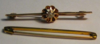 A gold bar brooch set a diamond and a plain gold bar brooch