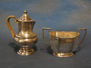 A circular silver plated hotwater jug and a matching twin handled sugar bowl with hotwater jug