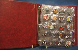 An album of various enamel lapel badges including Butlins, Union badges, sports badges etc