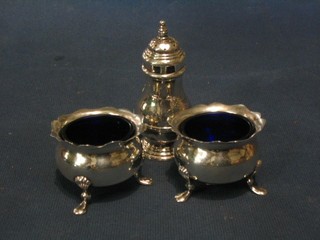 A pair of Victorian circular silver salts with cut borders and blue glass liners, raised on 3 hoof feet, Sheffield 1898 together with a silver pepper with armorial decoration raised on a spreading foot