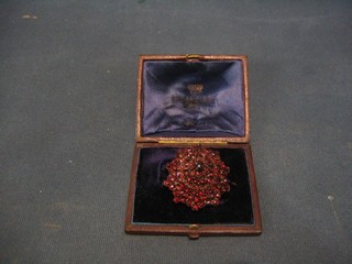 A Victorian gilt metal and garnet brooch, cased