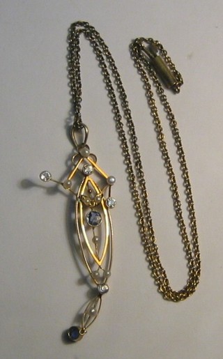 An Edwardian gold pendant set sapphires and pearls hung on a gold chain