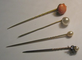 A coral stick pin, a gold and diamond stick pin and 2 pearl stick pins