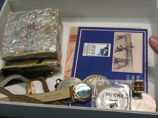 2 packets of Players cigarettes, 4 wristwatches and a small quantity of commemorative coins