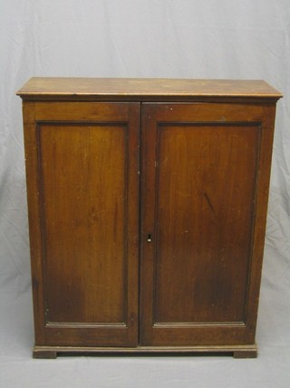 A Georgian mahogany cabinet, the shelved interior enclosed by panelled doors, raised on bracket feet 36"