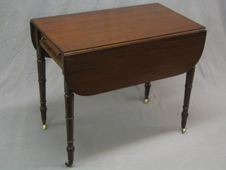 A Georgian mahogany Pembroke table, fitted a frieze drawer and raised on ring turned supports ending in brass caps and castors 33"