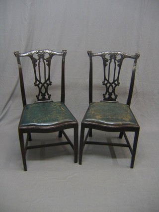 A pair of Chippendale style pierced splat back dining chairs with upholstered drop in seats