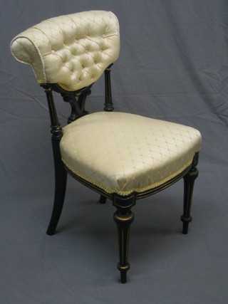 A pair of Victorian ebonised salon chairs with upholstered seats and backs, raised on turned and fluted supports