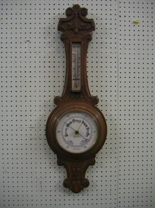 An aneroid barometer and thermometer with porcelain dial contained in a wheel case by Aitchison London and Provinces
