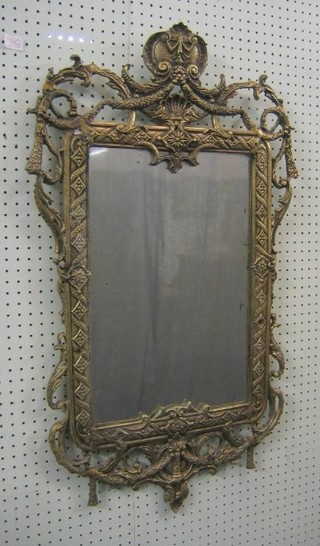 A rectangular plate mirror contained in a cast metal frame