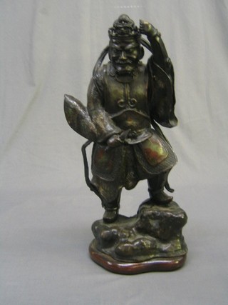 A 19th Century Oriental bronze and enamelled figure of a standing warrior on a rocky outcrop 21" (missing staff)