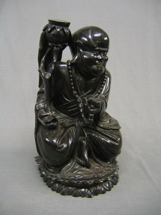A large carved wooden figure of a seated Buddha with worry beads and ivory teeth 20"