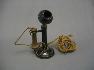 A hand metal candlestick telephone the mouth piece marked W-26 400/1
