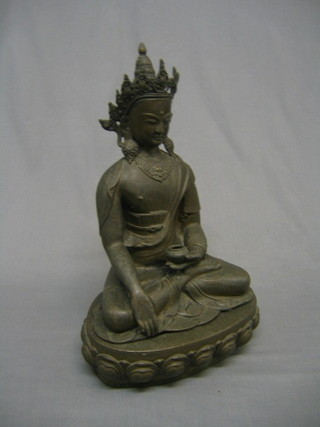 A 20th Century bronze figure of a seated Buddha raised on a stand 18"