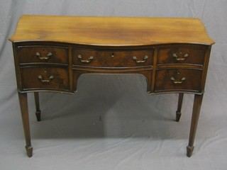 A 1930's Georgian style dressing table of serpentine outline, fitted 1 long and 4 short drawers, raised on square tapering supports ending in spade feet 42"