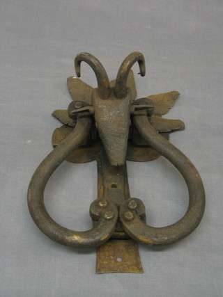 A wrought iron door knocker in the form of a rams head (reputedly removed from a French farm house)