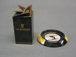 3 pressed metal Guiness advertising ashtrays "Guiness Isn't Good For You" together with 3 boxed Guiness glasses