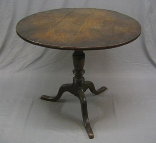 An 18th/19th Century circular snap top tea table, raised on pillar and tripod supports 34"