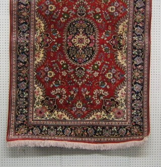A fine quality 20th Century Oriental rug with central medallion within floral borders 59" x 41"