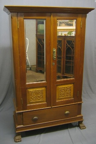 A 20th Century Eastern hardwood wardrobe, the interior fitted a rail and 2 drawers to the base enclosed by a rectangular bevelled plate mirror panelled door, raised on paw feet, 44"