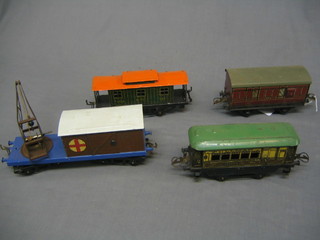 A  Hornby LMS O gauge guards van, a Pullman carriage Aurora, an LMS crane and a NYC van,