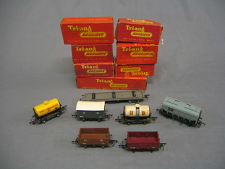 A Triang O gauge Bolster wagon R110,  a grain wagon R215, a Shell Lubrication Oil wagon yellow, a tank wagon R12, a goods truck R10, a fish van R14, an open truck R112, all boxed