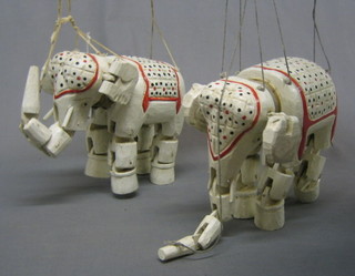 A pair of Eastern wooden painted puppets in the form of elephants