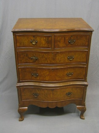 A 1930's Queen Anne style walnut serpentine fronted chest of 2 short and 2 long drawers, raised on cabriole supports 28"