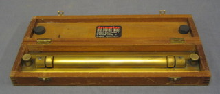 A brass rolling ruler, cased