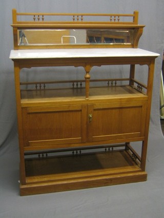 A 20th Century Eastern hardwood buffet, the raised mirrored back with marble top above niche with cupboard and potboard below, raised on a platform base 49"