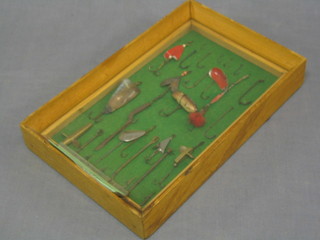 A collection of fishing hooks and lures, framed