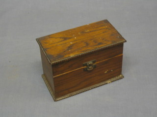 A rectangular oak box with hinged id 7"